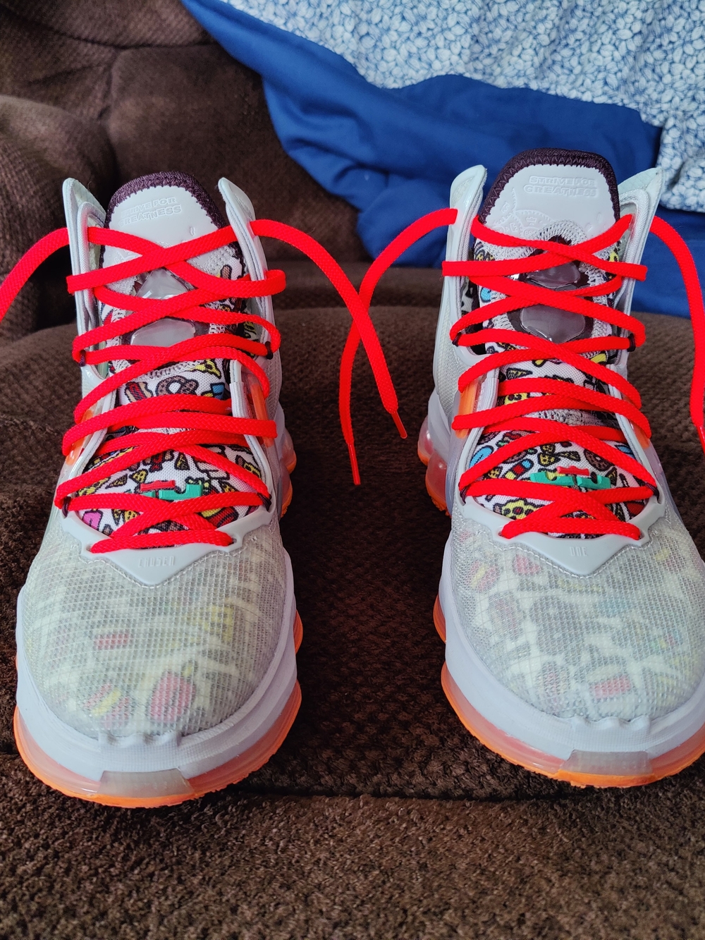 Light White Athletic Sneakers with Bright Red Laces and Orange Accents